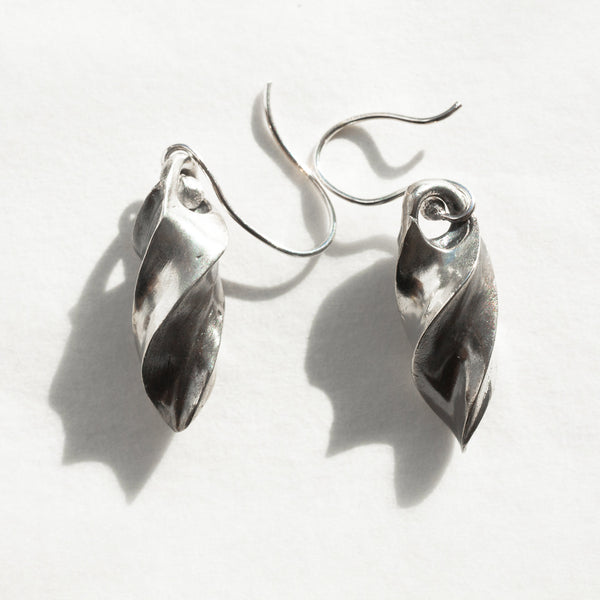 twirl sterling silver earrings in a natural light