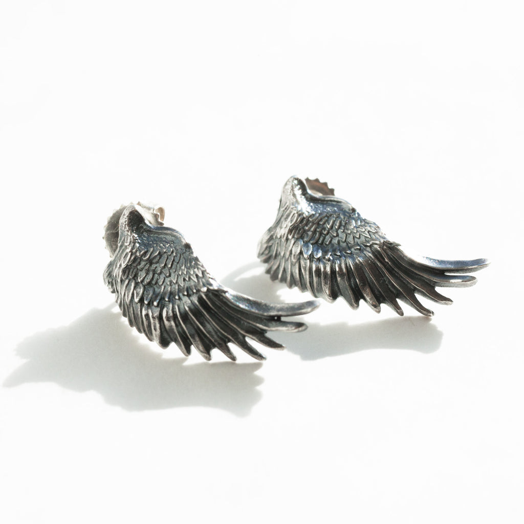 wing earrings, sterling silver, seen in a natural light