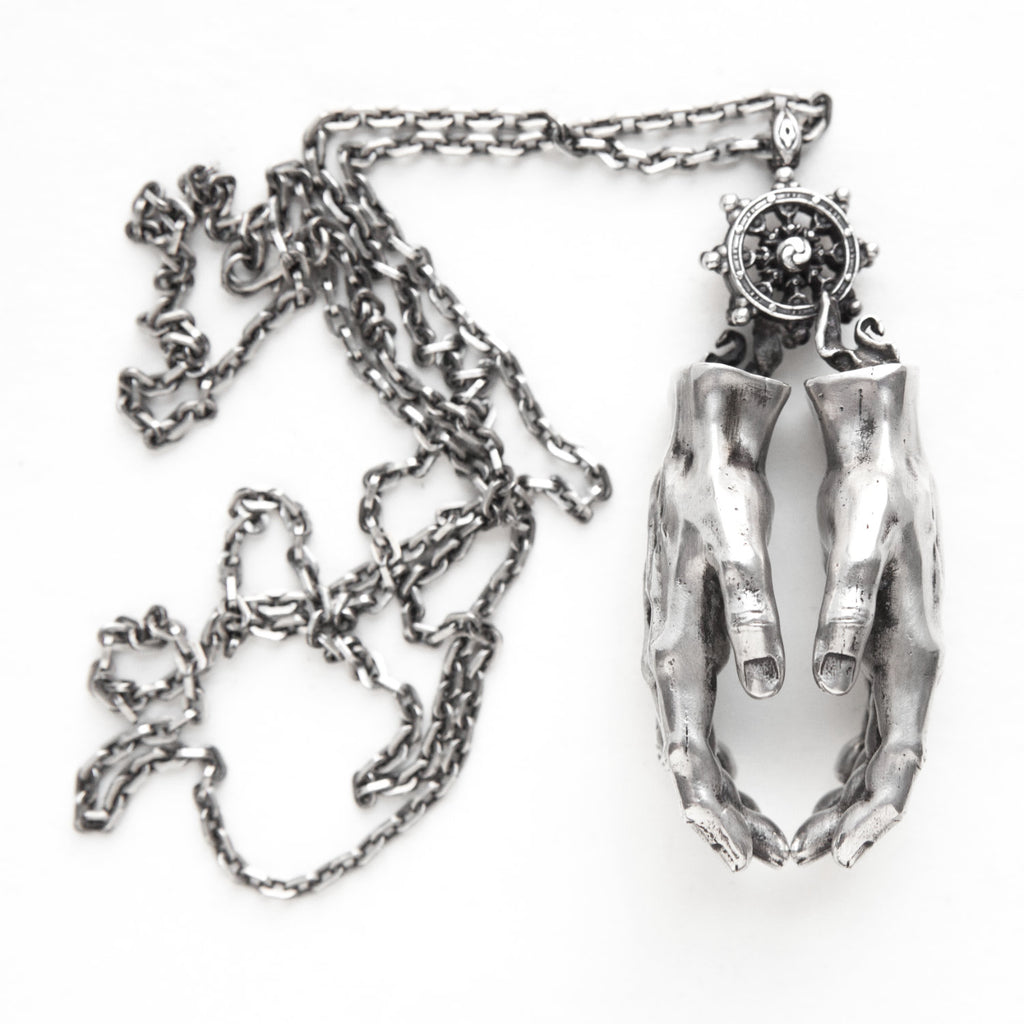 Silver hands pendant opens to reveal hidden eyes-front