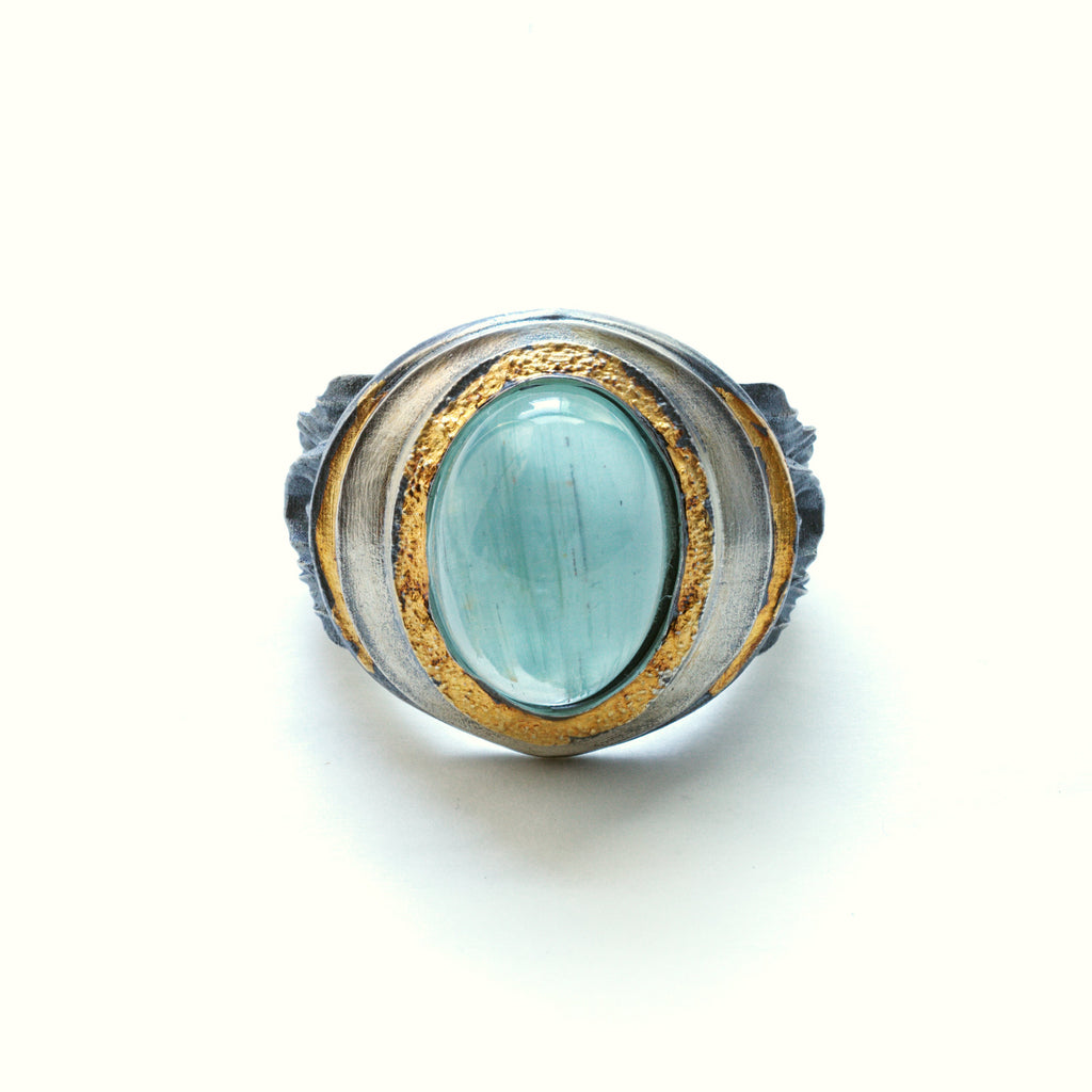 organic chrysler building ring, blackened sterling silver, 24k golf foil fused to the silver, oval aquamarine cab. Front