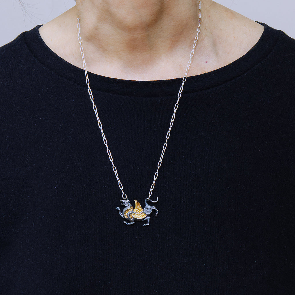 blackened silver and gold tiger with wings necklace. as worn