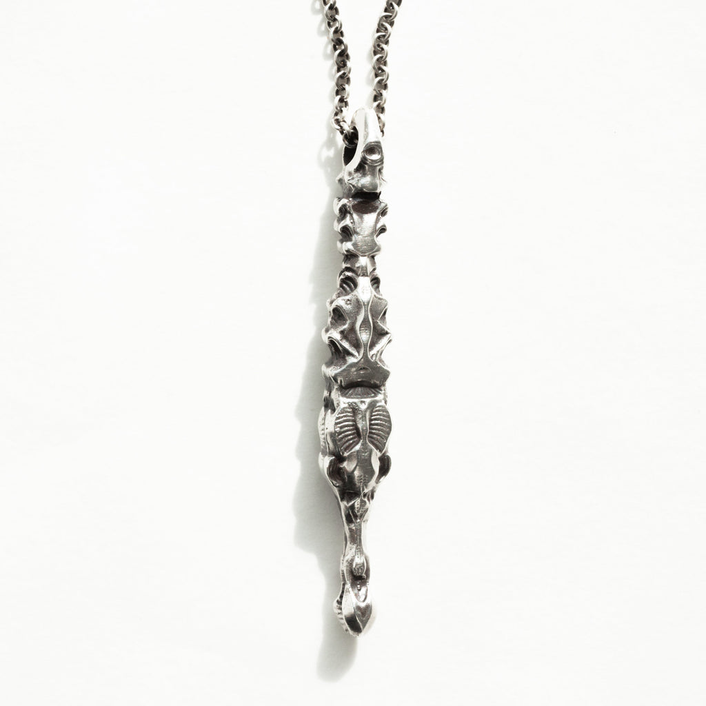 alligator/crocodile silver pendant swimming in water with reflection.