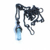 Aquamarine in a blackened silver baby monster setting. front with chain and clasp