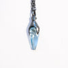Blackened silver animal like pendant with an untreated aquamarine and 17" chain. From the side.