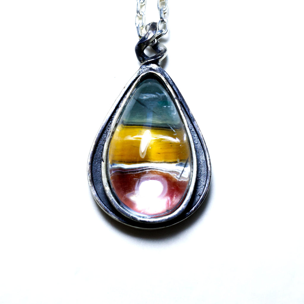 aquamarine teardrop, sterling silver necklace with green, yellow and red cabs underneath. Front