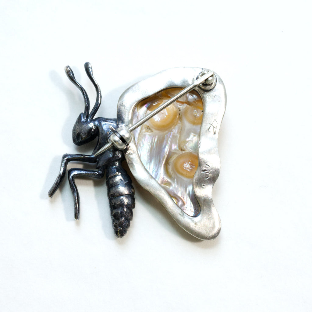 Baroque pearl winged butterfly with a sapphire eye, sterling silver partly blackened. Back