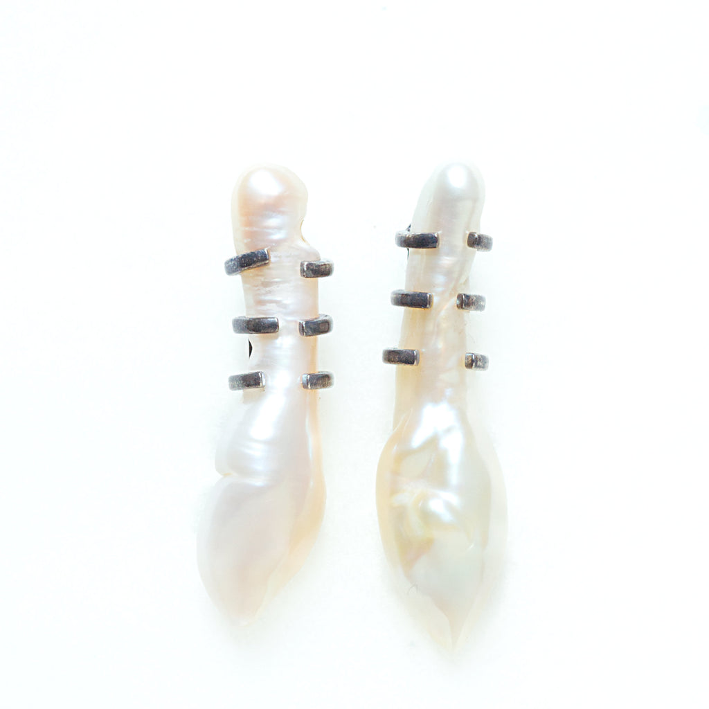 Unusual baroque pearl silver earrings with shoe lace mounts. Front