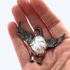 baroque pearl swan sterling silver brooch in a hand to see the size