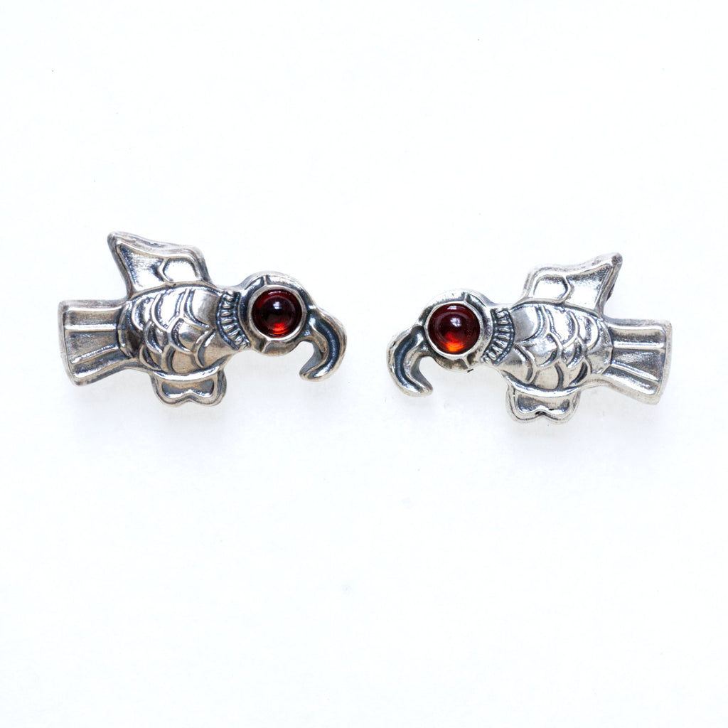 Big Feathers sterling silver earrings with red garnet eyes. Based on Frankish Brooches-front.