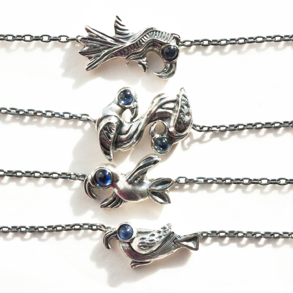 all the bird necklaces with blue saphire cabochons for eyes