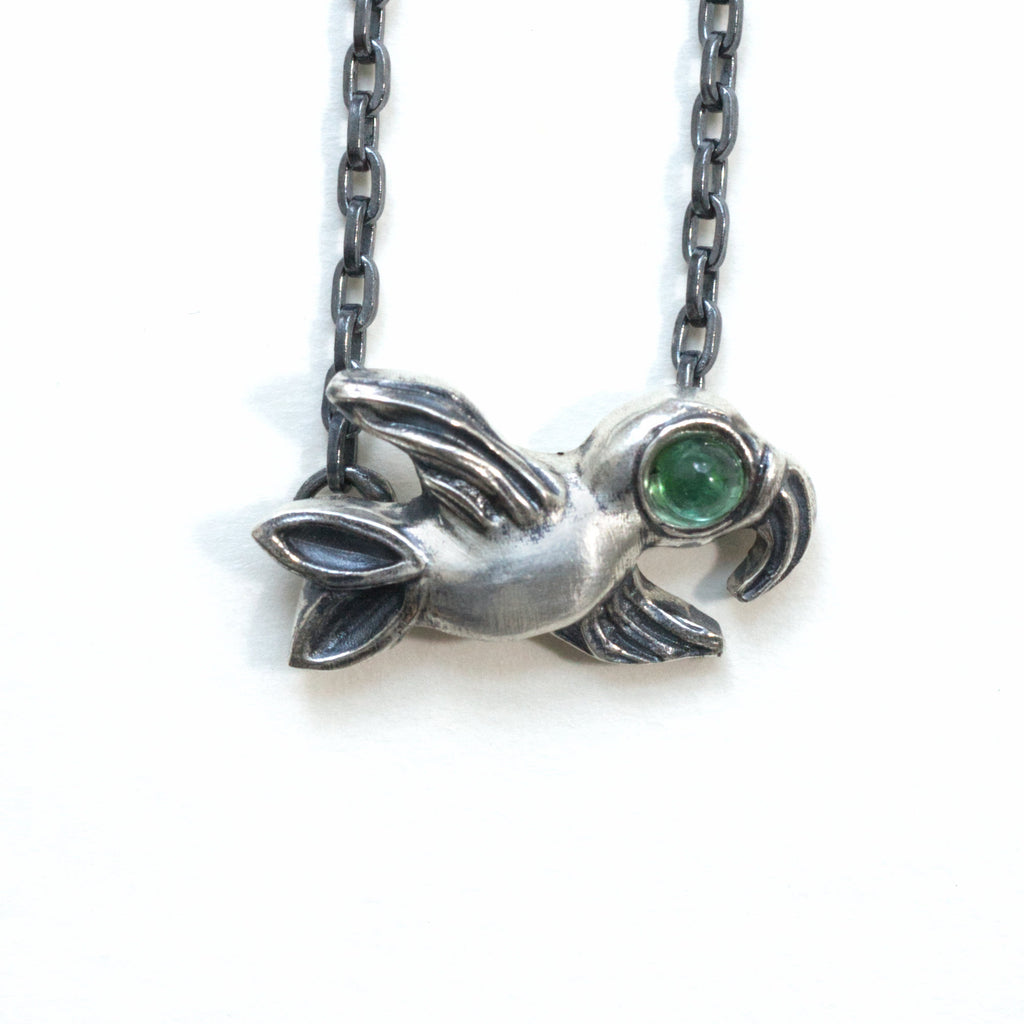 flying bird silver with green tourmaline eye