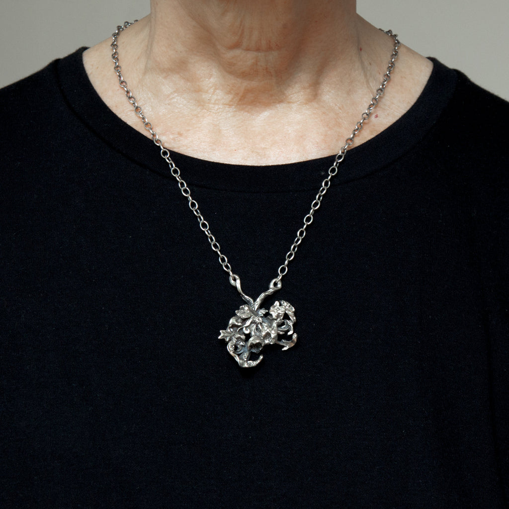 bouquet of flowers silver pendant seen as worn