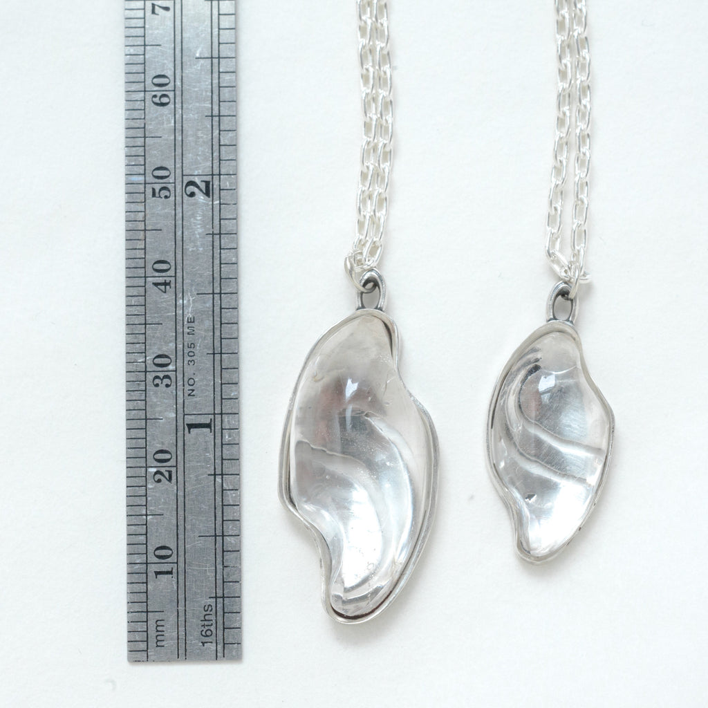 carved quartz silver necklaces with design on the back. measure