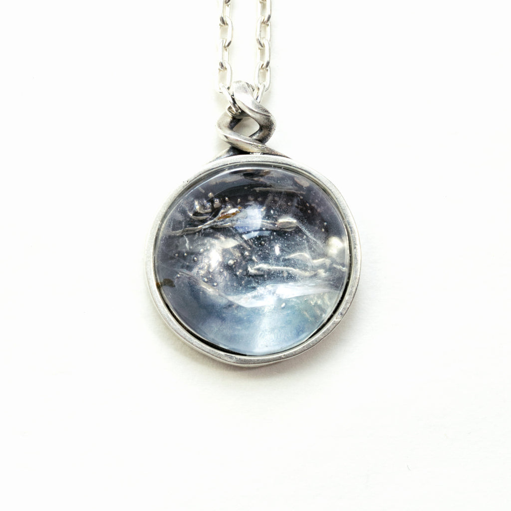 clair de lune white topaz necklace with a night scene behind the gemstone. Front