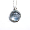 clair de lune white topaz necklace with a night scene behind the gemstone. Front. Another view