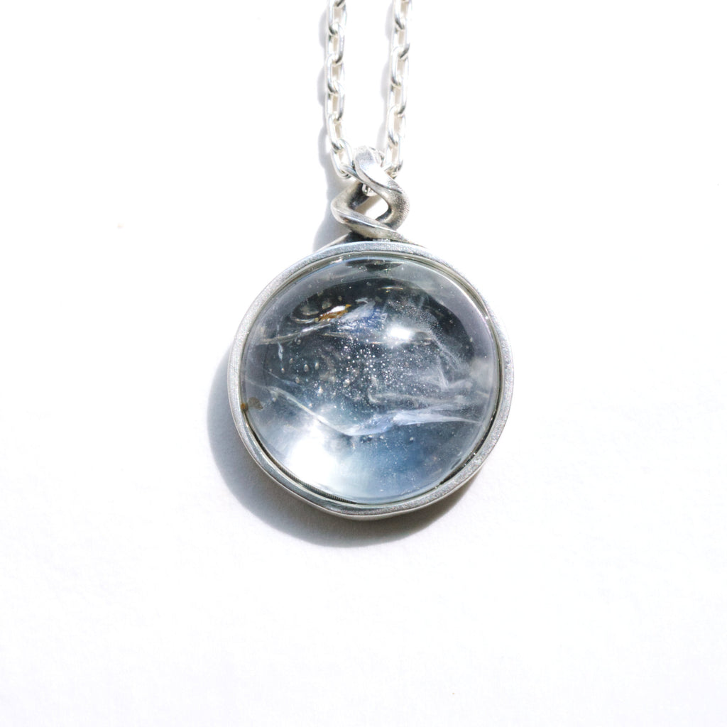 clair de lune white topaz necklace with a night scene behind the gemstone. Front. Another view