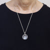 clair de lune white topaz necklace with a night scene behind the gemstone. As worn.