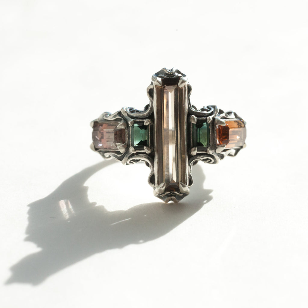 five tourmalines, orange and green, on a silver ring band with spirals, front