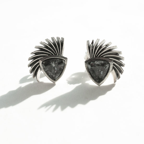 grey spinel wig and shield earrings shown in a natural light