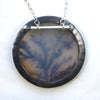 Round dendritic agate bush with golden swallows flying by. Brooch pendant. Back.