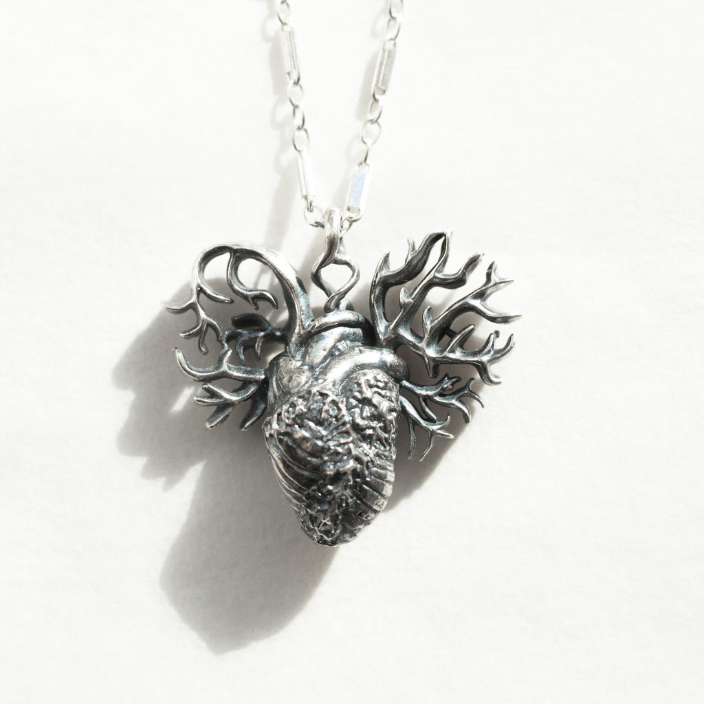 detailed anatomical heart pendant,  with a shadow-front