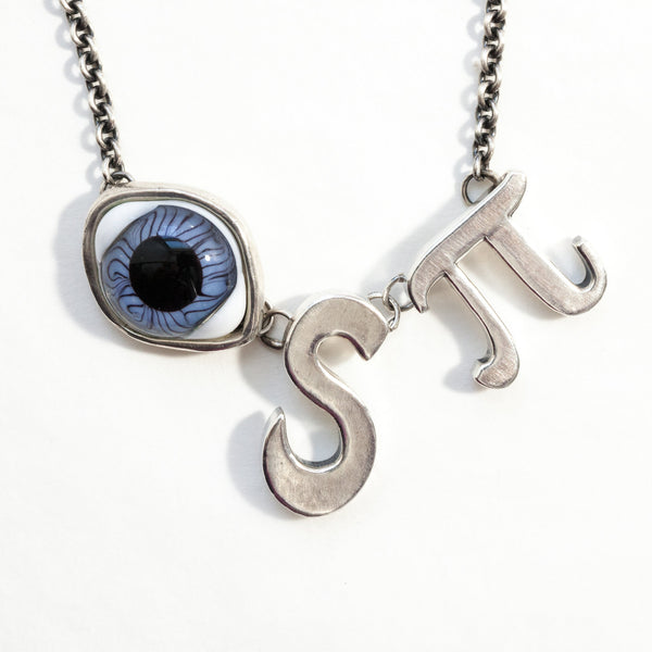I spy silver necklace with glass doll's eye in natural light