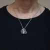 Sterling silver vote offering pendant shown being worn.