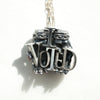vote offering silver pendant with red nail polish in different light
