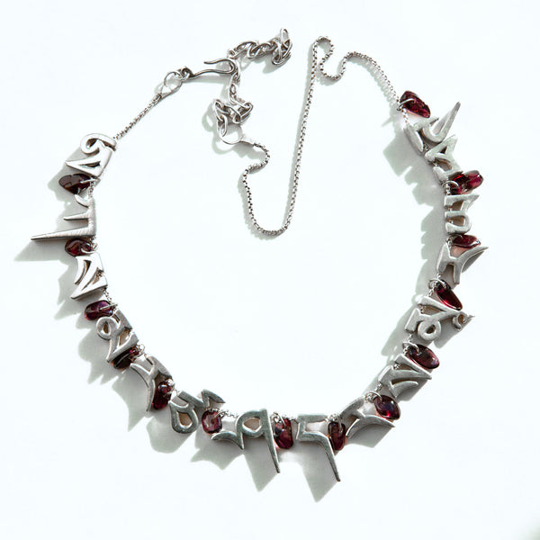 mantra necklace with 13 rock tumbled purple garnets, silver Tibetan letters with a atural shadow