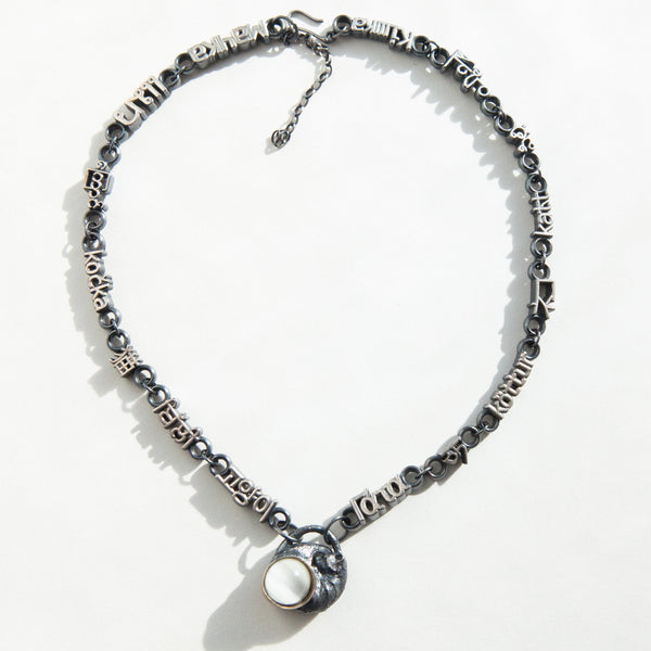 midnight moonstone cat necklacewith a cats eye moonstone and cat in fifteen languages as beads in natural light