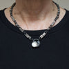 midnight moonstone cat sterling silver necklace with a cats eye moonstone is show n being worn.