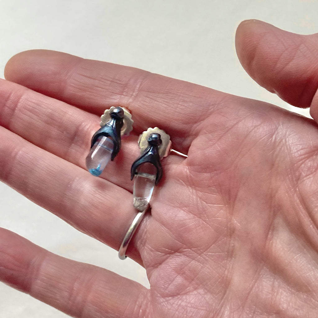 mis-matched aquamarine earrings shown on hand for size