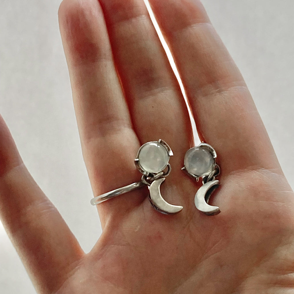 moonstone moon sterling silver earrings shown in a hand for size comparison