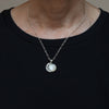 Moonstone moon sterling silver necklace shown being worn.