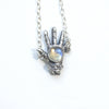 The front of the open giving silver left hand with rainbow moonstone