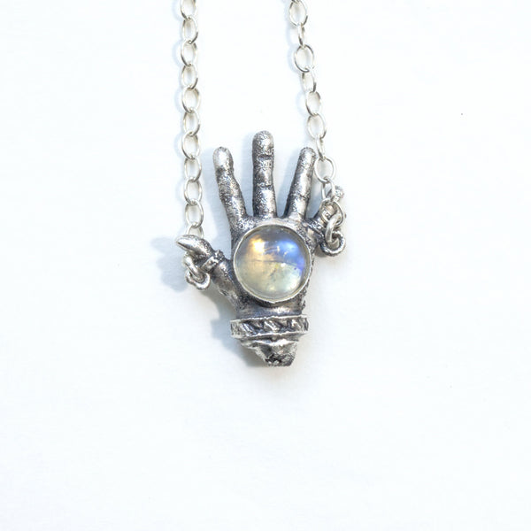 The front of the open giving silver left hand with rainbow moonstone