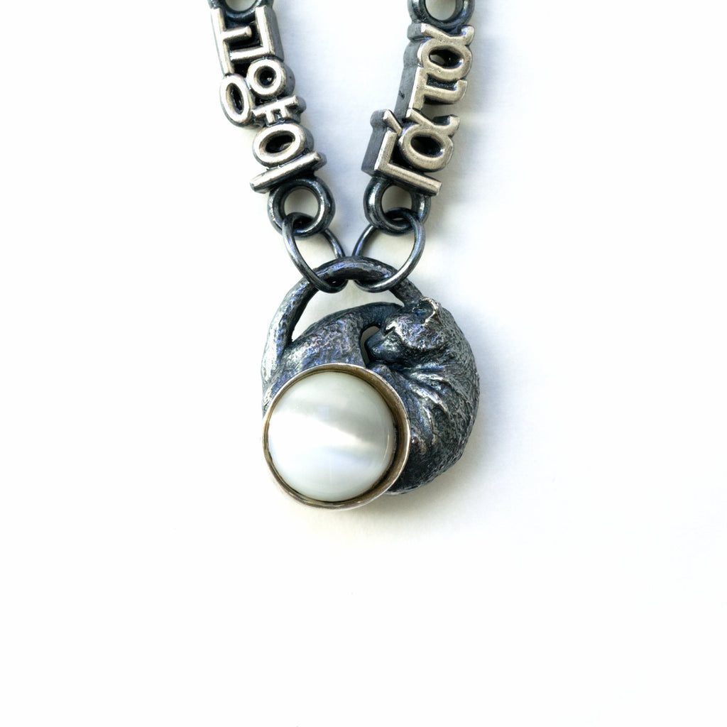 sleeping cat silver necklace cats eye moonstone closeup of cat and moonstone