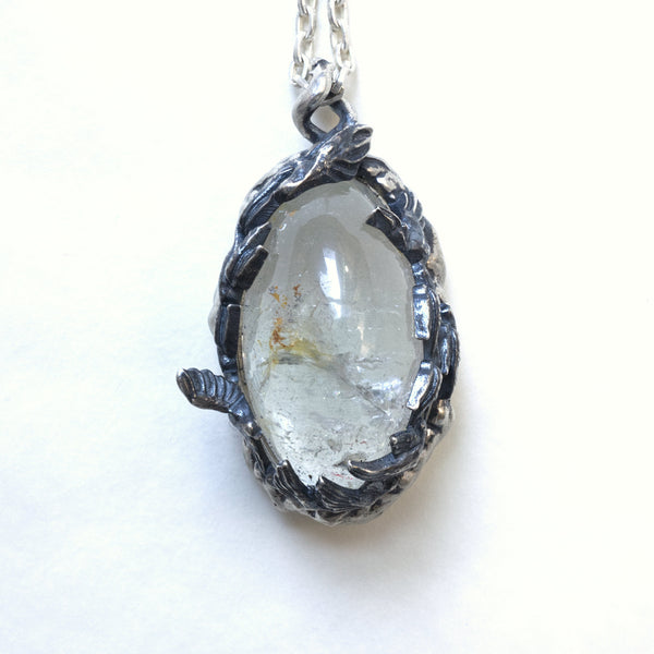 A very included topaz with sterling silver swallow and cloud setting. Front