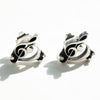 the treble and bass are combined into one sterlinng silver pair of earrings in a natural light