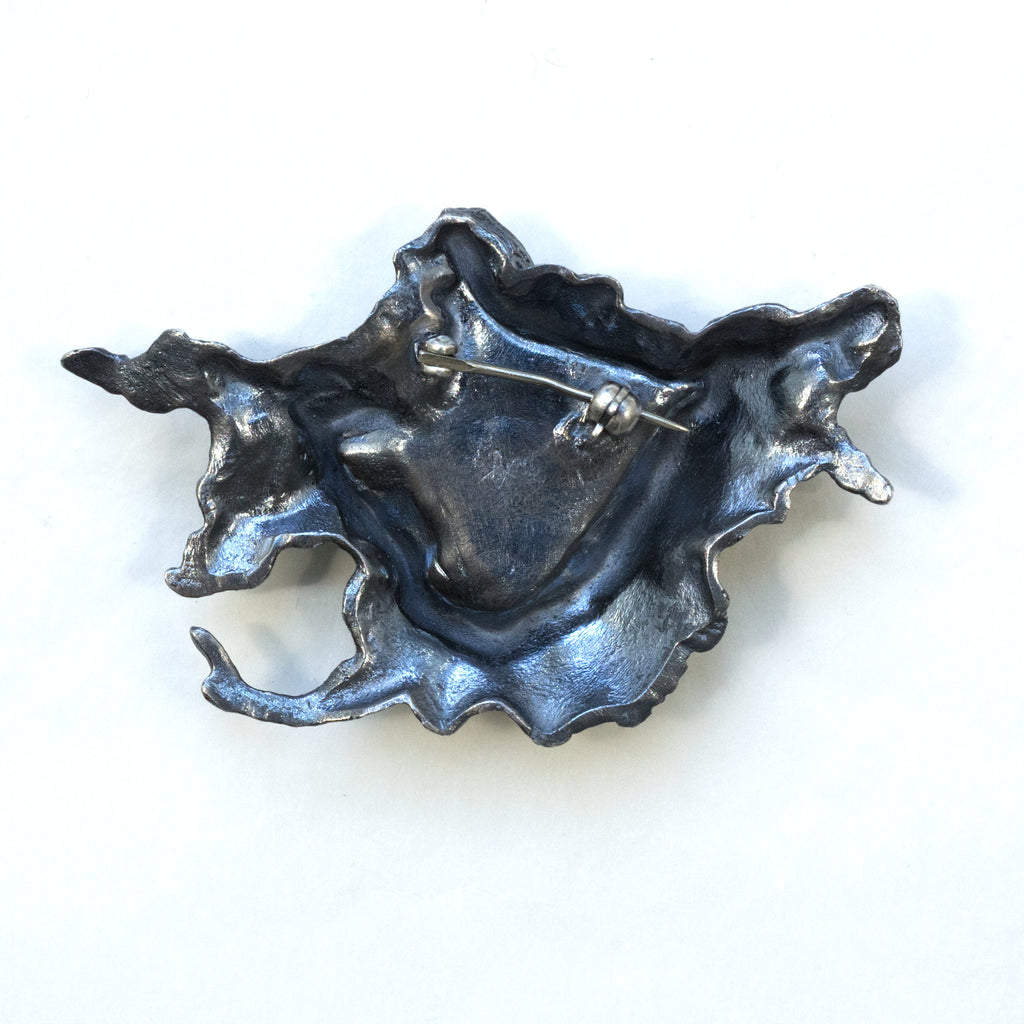 A photo scanned tree stump in blackened sterling silver with 24k gold foil fused using keum boo. A brooch, Back.