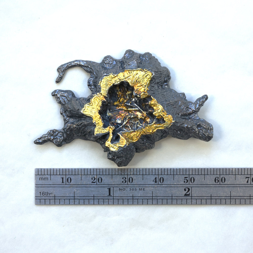 A photo scanned tree stump in blackened sterling silver with 24k gold foil fused using keum boo. A brooch, Measured
