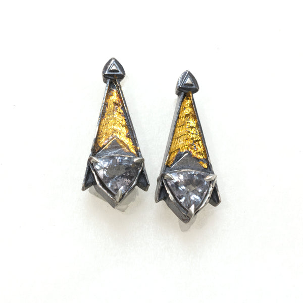 Grey spinel tri post back earrings. BLackened siver 24k gold foil fused to the silver. triangular grey spinels.Front