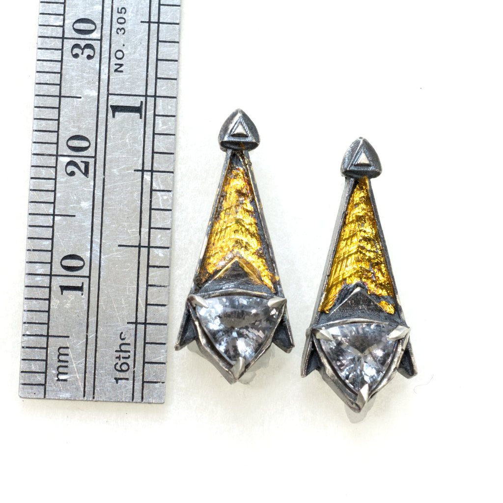 Grey spinel tri post back earrings. Blackened siver 24k gold foil fused to the silver. triangular grey spinels.Measure