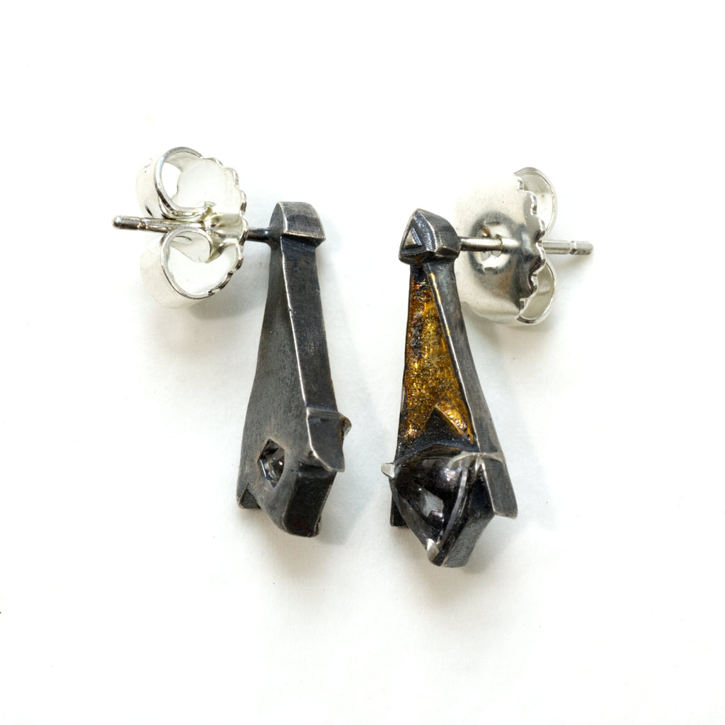 Grey spinel tri post back earrings. Blackened siver 24k gold foil fused to the silver. triangular grey spinelsSide view so you can see the posts and backs