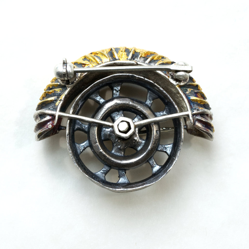 yaya fender brooch pendant. Blackened sterling silver, 24k gold foil applied using keum boo. The hubcap spins. Back