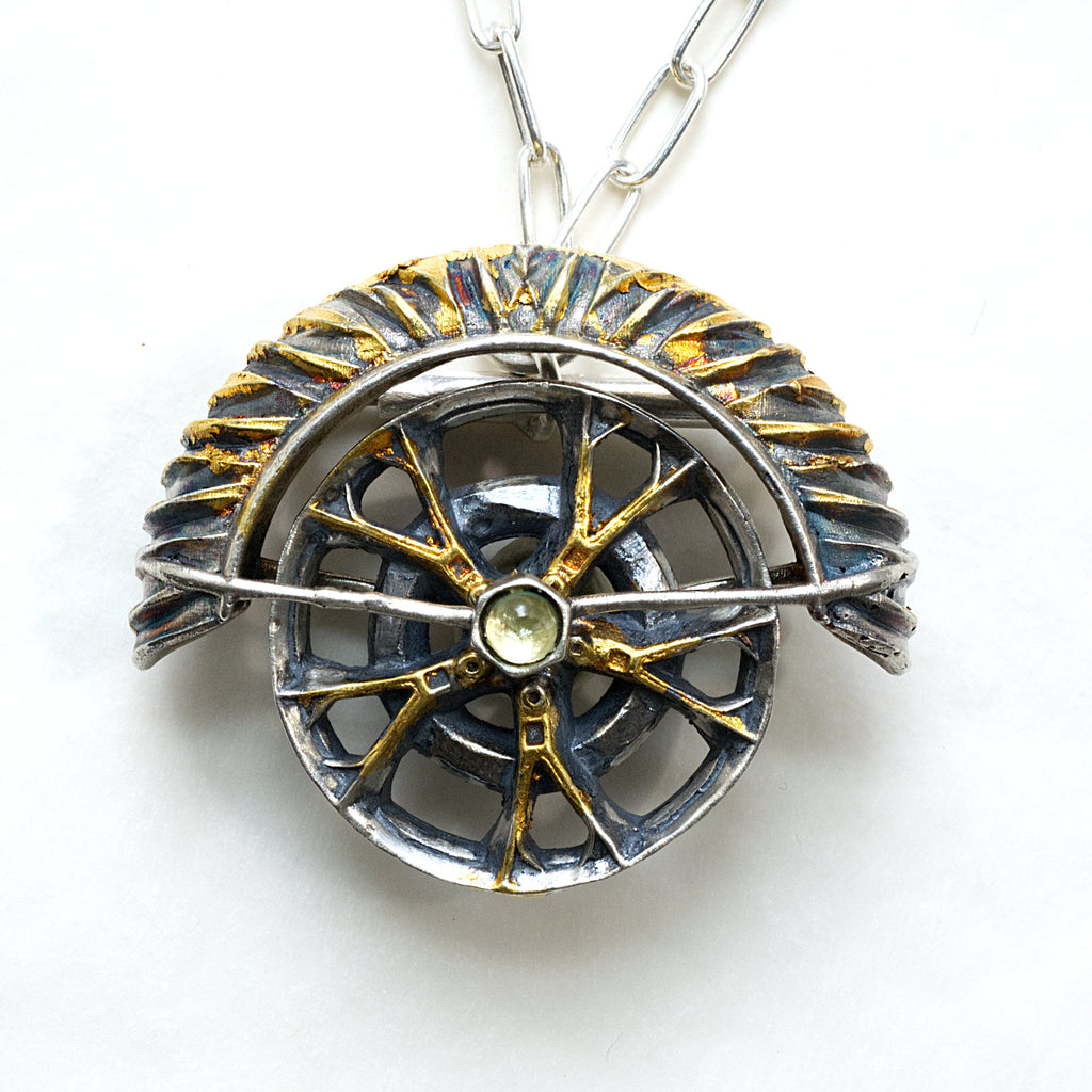 yaya fender brooch pendant. Blackened sterling silver, 24k gold foil applied using keum boo. The hubcap spins. front with chain