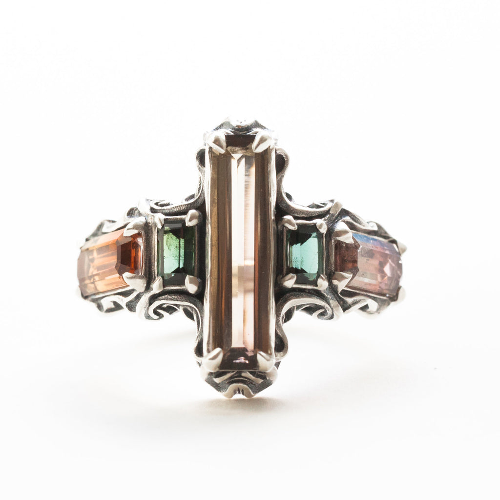 five tourmalines, orange and green, on a silver ring band with spirals, front