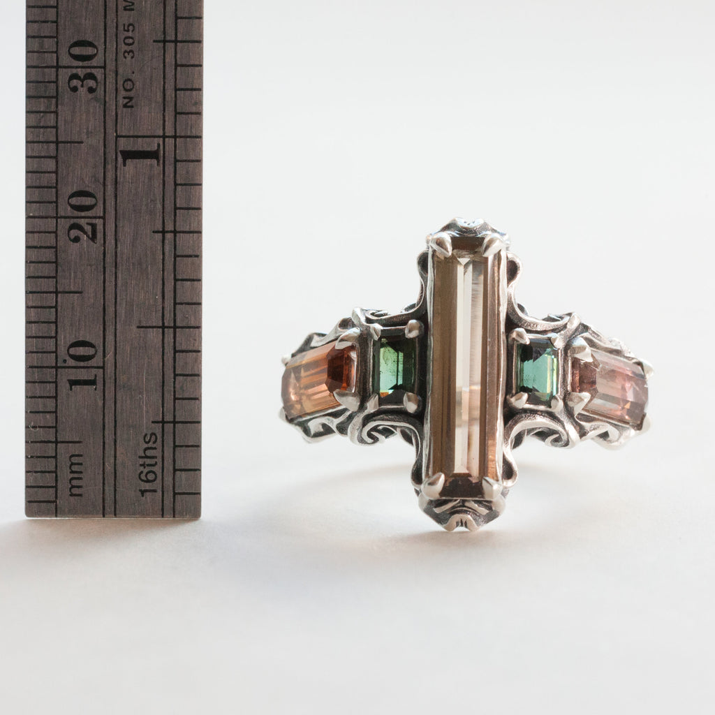 five tourmalines, orange and green, on a silver ring band with spirals, measure