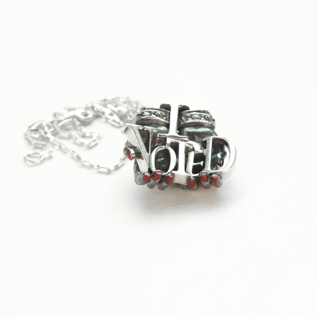 vote-offering-silver-pendant-front-red-finger-nails