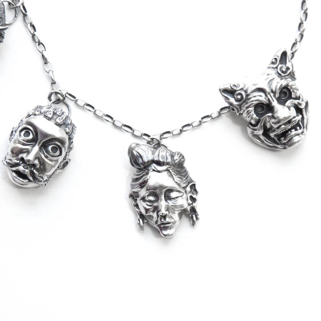 detail of the right side faces on the sterling silver expressions necklace.